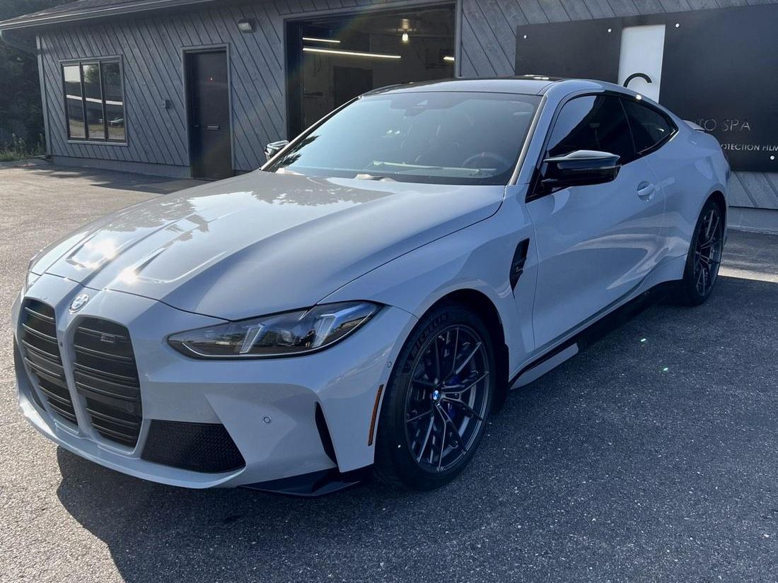 A grey BMW M4 finished at Central Wisconsin Auto Spa, parked outside the shop in Weston